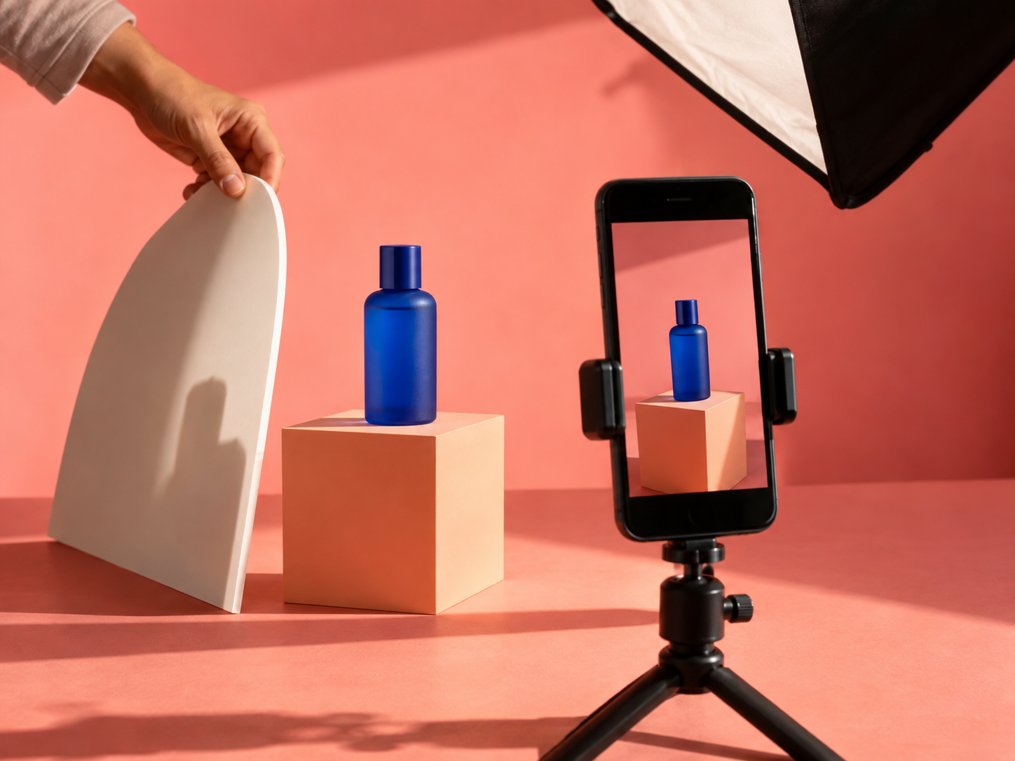 Creator filming a skincare product campaign in a pink studio set